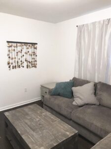 Photograph of living room with comfortable couch and coffee table in furnished unit for rent to travel nurses in Johnson City, TN